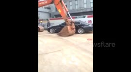 Digger ploughs through cars amid China construction dispute