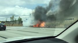Truck engulfed in flames on side of highway in Québec, Canada.