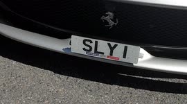 A Silver Grey Ferrari With Registration Plate SlyI