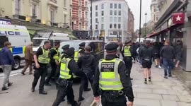 Police use batons to stop England fans forcing their way into Scottish fan crowd