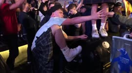 D'oh! Drunk Scotish soccer fan falls of trash bin in Leicester Square