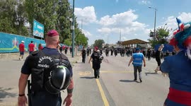 Hungarian police and the French fan walk to the stadium