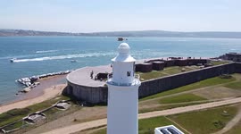 Amazing aerial drone view of the Isle of Wight, Hurst Castle and Lighthouse in the Solent. Sunny Summer travel in the UK