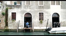 People in a window restaurant in Venice, canal, during Covid19 lockdown