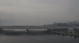 Perth Narrows Bridge traffic and train on a burn off and foggy morning
