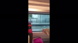 Train passes through flooded station after severe storm hits Paris area