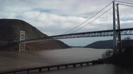 CSX Train chugs along the Hudson River underneath the Bear Mountain Bridge