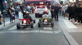 Two karts cruising in the streets of Paris. Music Festival turns crazy after the end of some covid restrictions (as the curfew)