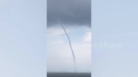 Giant waterspout forms off coast of village in the Philippines