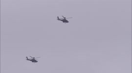 Four Apache military helicopters fly in close formation over Kent, UK