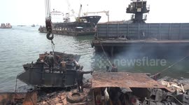 Workers on Indonesian beach break down discarded ships into scrap metal