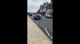 Suburban high street in a working class part of North East England on an overcast summers day.