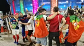 French and Portuguese fans celebrate their team qualification together while leaving Budapest's Puskas Arena