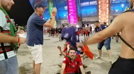 French and Portuguese fans celebrate their team qualification together while leaving Budapest's Puskas Arena