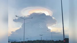 Beautiful hat-shaped cloud iridescence appears in sky in Thailand