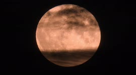 Spooky strawberry full supermoon rising like a Death Star over Wirksworth Derbyshire on the final day of filming Star Wars Andor