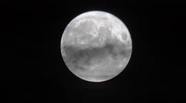 Strawberry moon vanishes behind thick clouds in London