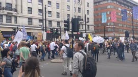 Mass anti-lockdown protest marching down Oxford Street near Marble Arch