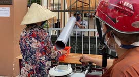 Church in Vietnam gives to the poor through socially distanced plastic pipes