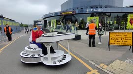 Entertainer as Elton John performs on mobile piano at Watford FC vaccination centre
