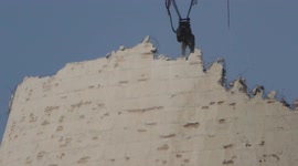 A huge tool is used to demolish water cooling tower of Bazan oil refinery