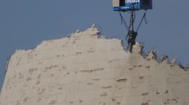 A huge tool is used to demolish water cooling tower of Bazan oil refinery