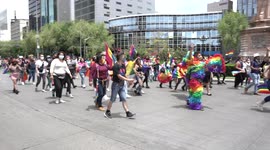 Pride Parade in Mexico City, People marching in Reforma Av, Camera pans right