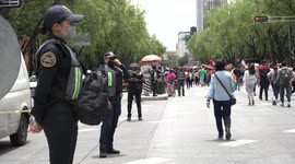 Pride Parade in Mexico City, people marching in Reforma av, police on a side