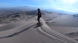 Put this on your travel bucket list! Sand surfer glides down dunes in Chile