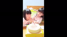 Adorable little girl can't wait to blow out birthday candle