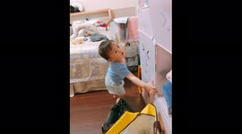 Little cute boy can't figure out how to keep storage box door open and fail again and again!