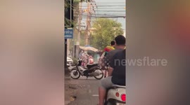 Dramatic moment motorcycle bursts into flames as rider battles to contain blaze