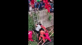 Indonesian man has to be pulled from narrow culvert after chasing lizard into sewer