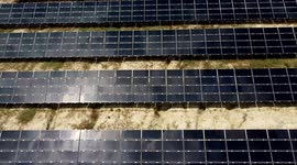 Solar panels farm aerial view from drone shot.  Small photovoltaic cell panels field or farm in an agricultural field.