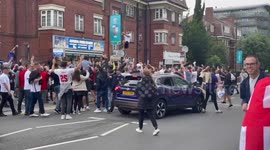 England fans jump up and down and climb up lampposts outside Wembley after Germany win