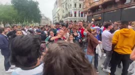 Brave German girls chant for their tean next to England celebration in West End