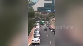 Debris ripped from buildings and lamp posts bent over as winds batter Chinese city