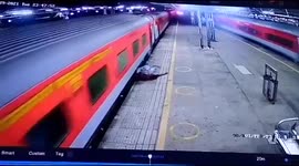 Passenger dragged along platform by train in India escapes serious injury