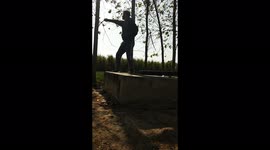 A young Indian boy is showing his funny Martial Arts skills in field