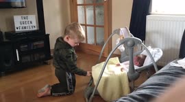 2 year old toddler rocks his 3 week old sister to sleep