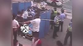 Police and paramedics help woman give birth outside train station in China