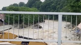 Excavator swept away by raging river in Kanagawa, Japan, during heavy rain