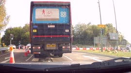 Dashcam - Dangerous Driving - Car crosses two lanes in front of driver, driving dangerously to get onto motorway slip lane on roundabout.