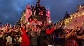 England fans climb Eros statue in London's Piccadilly Circus after Euros win