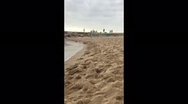 Tranquil beach in Barcelona Spain on an afternoon in the fall with people