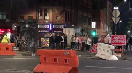 England Fans celebrate their victory, under the close watch of the police, in Manchester city centre