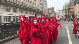 A group called Red Brigade appears in Extinction Rebellion protest held at Waterloo Bridge, London on April 16, 2019.