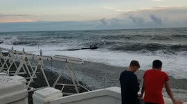 People watch the sea after the storm in Adler, Sochi, Russia