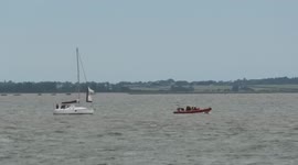 Harwich RNLI Inshore Lifeboat returns to harbour with disabled yacht at about 6pm on Monday 5 July 2021