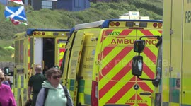Emergency services airlift injured person to hospital from cliff in Dorset, UK